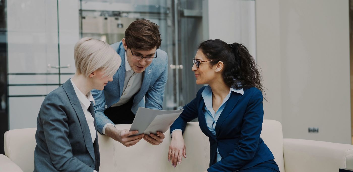 Three professionals reviewing a project together on a tablet